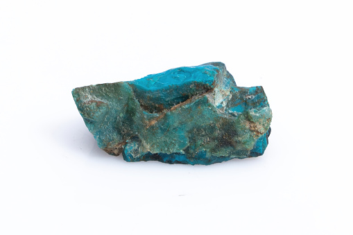 Natural Chrysocolla stone on a white background. Mineral of blue and bluish-green color
