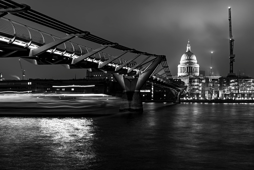 St Paul's Cathedral over the Thames at night with the Millennium bridge in the foreground.