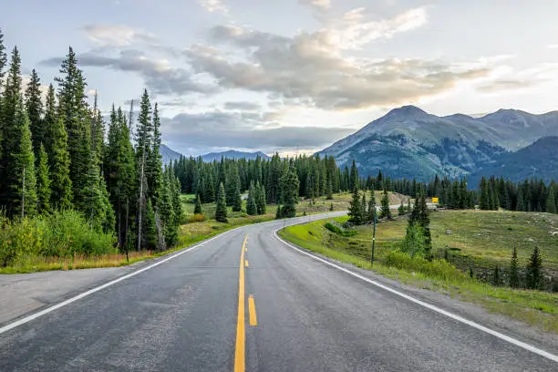 Photo of San Juan mountain range in Silverton, Colorado summer morning point of view from empty highway road to Durango in Rocky Mountains