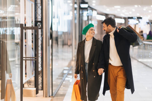 istock Happy young couple in a shopping mall 1446291409