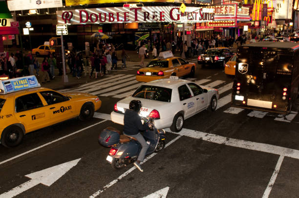 New York City, USA - April 16th 2010: People walking and traffic by night in Times Square, Midtown Manhattan.