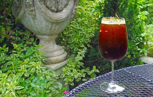 A Glass of Iced Coffee Served on Garden Tea Table