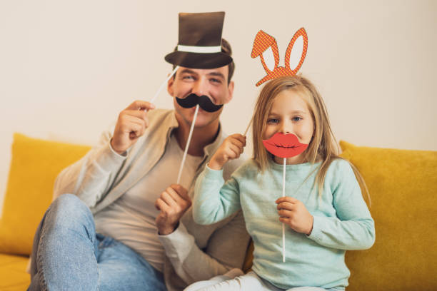 istock Father and daughter having fun with  party props 1446296204
