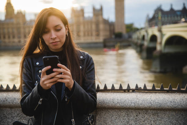 istock Woman using smartphone in London 1446296263