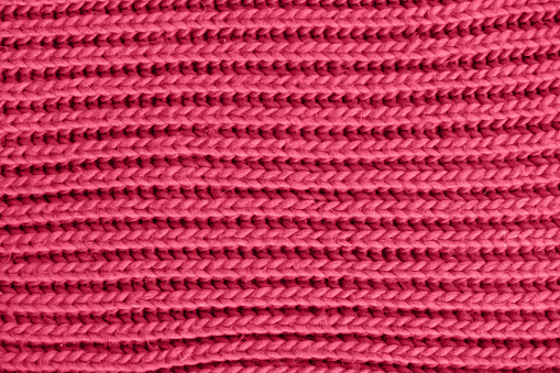 Viva magenta knitted texture. Wool yarn in knitting background. Trend Color of the year 2023