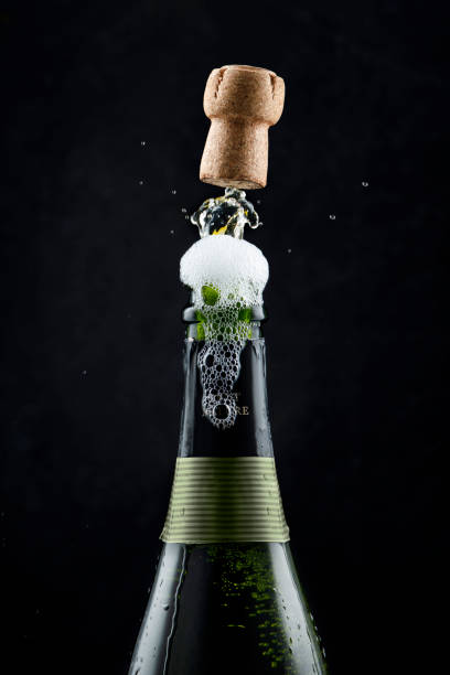 Champagne stopper jumping with the foam Champagne stopper jumping with the foam in Spain, Balearic Islands, Palma uncork wine stock pictures, royalty-free photos & images