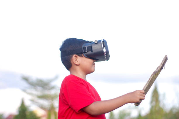 istock child playing Virtual reality outdoor 1446299739