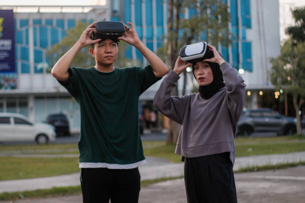 istock young couple playing Virtual reality outdoor 1446299908