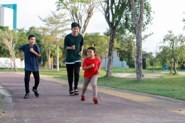 istock boy and brother exercising in city park 1446301090