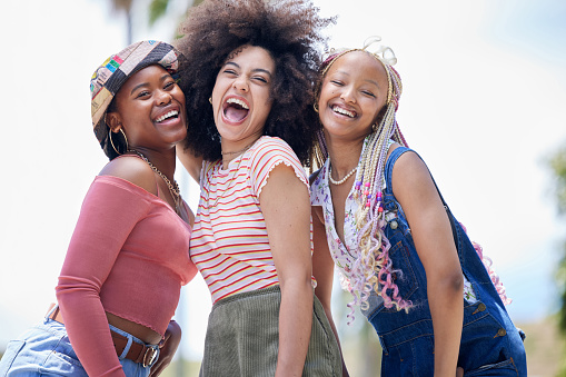 Group, girl and friends with happy, laughing and smile on face in outdoor sunshine. Black woman, happiness and summer together for vacation, holiday or relax in comic time on holiday in Cape Town