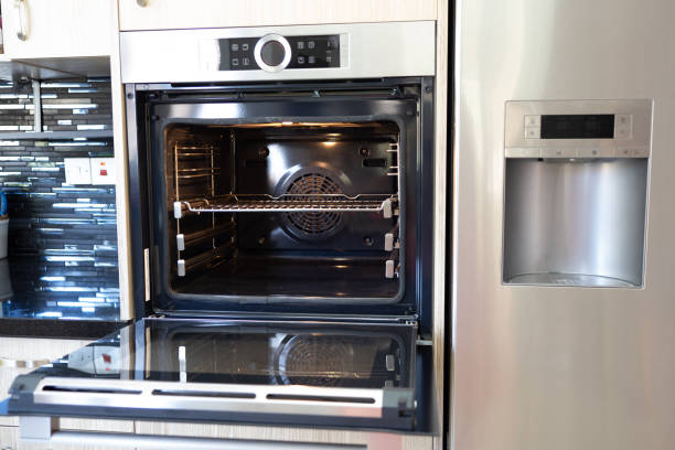 istock Open empty oven in a modern kitchen. Integrated oven with sliding shelves and electronic control 1446302450