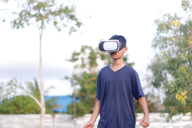 istock child playing Virtual reality outdoor 1446302869