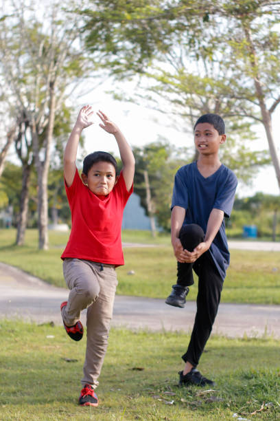 istock boy and brother exercising in city park 1446302888