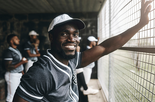 Baseball, training and portrait of coach in dugout, smile, relax and happy about sports vision, goal and mission. Sport, stadium and cheerful team trainer watching game with baseball player group