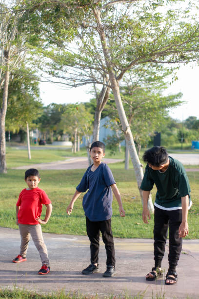 boy and brother exercising in city park