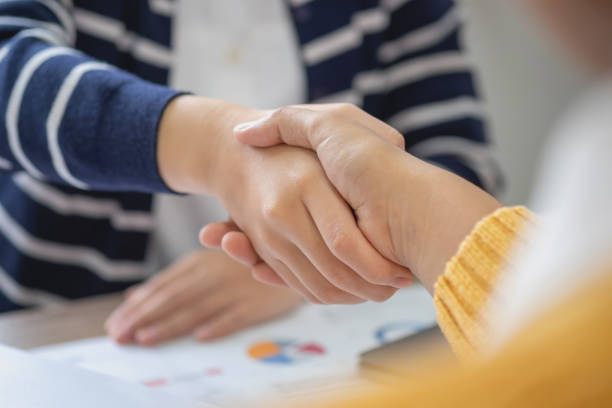 istock Company representatives join hands to work together on real estate projects and make profits for the company. 1446309526