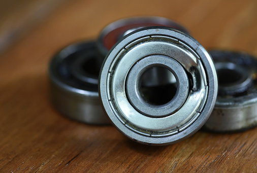 damaged ball bearing on the wood table .