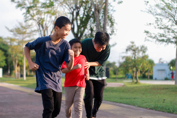 istock boy and brother exercising in city park 1446312390