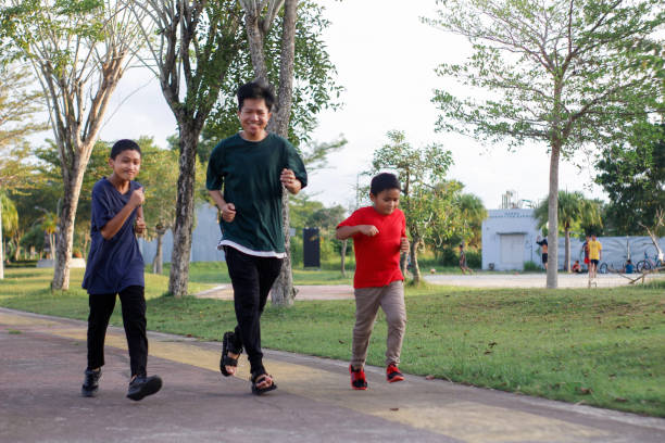 istock boy and brother exercising in city park 1446313079