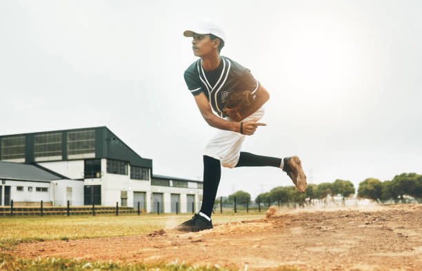 istock Sports, baseball and pitcher throw on baseball field at training game, match or competition. Health, workout and baseball player from Brazil practice pitch for strength, fitness or exercise outdoors 1446313171