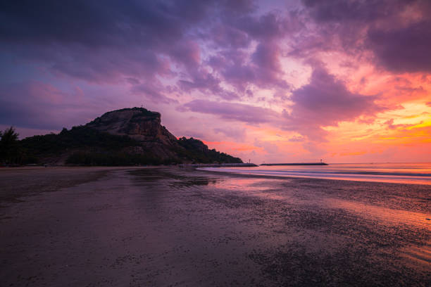 istock Beach and mountains at sunrise,Sunset at tropical beach. Ocean waves by sunrise. Beautiful landscape of exotic island at dawn. 1446314607