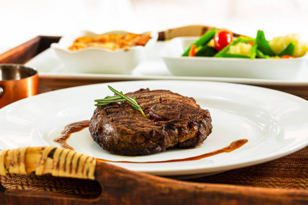 istock beef steak,Modern style barbecue dry aged sliced roast beef with fried onion rings and mashed potatoes as closeup on a plate 1446314766