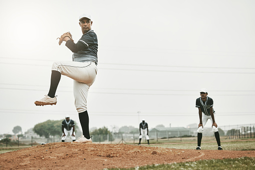 Baseball, pitcher and sports with man on field of stadium for training, practice and workout. Fitness, exercise and action with athlete throwing ball in game in park for competition, match and skill