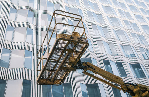 istock cherry picker to do maintenance work on a building facade. 1446319197