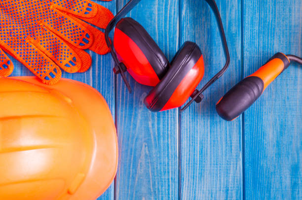 istock Orange hard hat and tool on wooden vintage blue boards 1446325644
