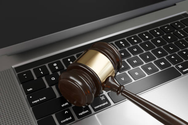 Judge gavel on a laptop. Illustration of the concept of new cybersecurity laws and regulations and its enforcement Judge gavel on a laptop. Illustration of the concept of new cybersecurity laws and regulations and its enforcement synthetic identity theft stock pictures, royalty-free photos & images