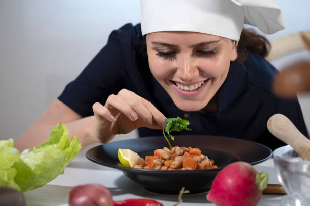 chef woman preparing food at restaurant kitchen