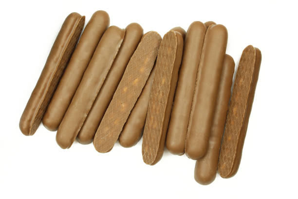 Pile of chocolate coated wafer sticks isolated on white background Pile of chocolate coated wafer sticks isolated on white background chocolate fingers stock pictures, royalty-free photos & images