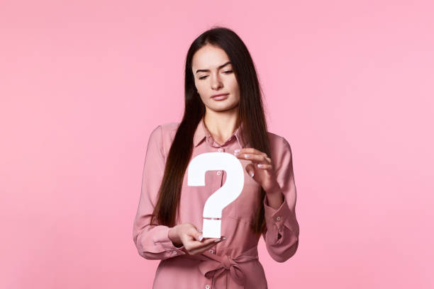 istock woman with question mark on pink background 1446333475