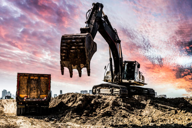 istock Excavator working at construction site against sunset background 1446333534