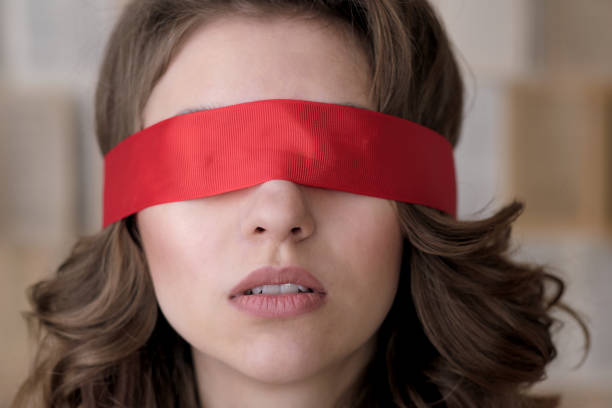 Middle-aged man, wearing blindfold, awaits his fate.