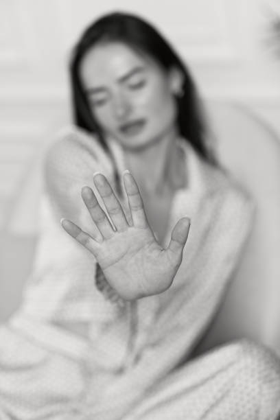 istock woman showing stop gesture. black and white 1446334309