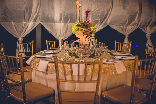 View of an event table with decoration and floral arrangements for events and celebrations.