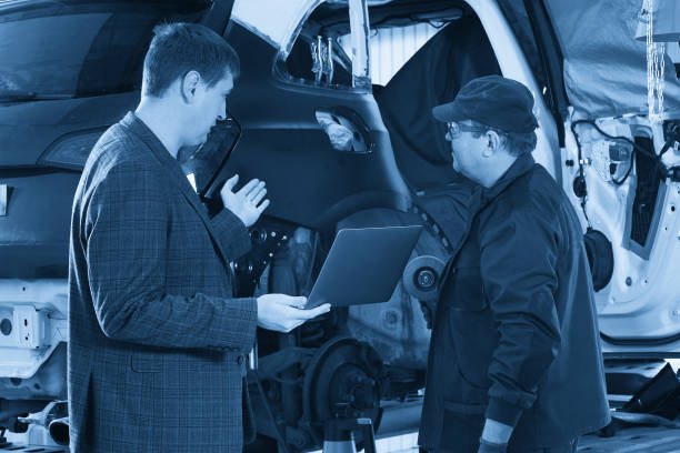 istock Auto mechanic and technician working in repair shop 1446334851