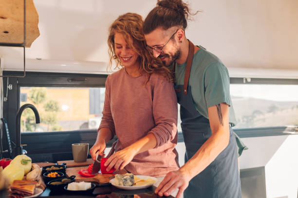 istock Young couple making breakfast together in the kitchen at home 1446339575