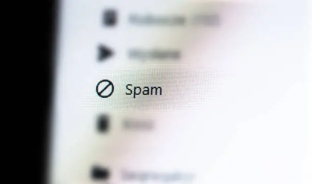 Photo of Spam messages folder in a generic email client web app, unwanted mail ads spam e-mail AI filtering, message filters, phishing mitigation abstract concept, nobody. Desktop PC, computer monitor, screen