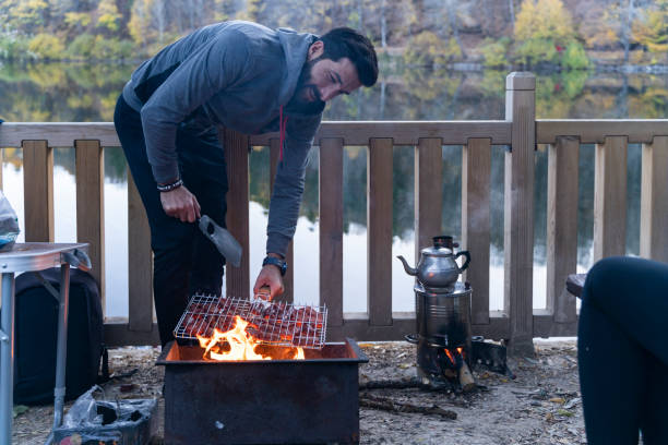istock man cooking sausage on barbecue 1446342663