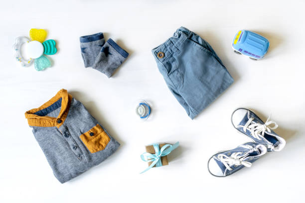 istock Different child toys, clothes, accessories, gift box on white table with copy space, flat lay. Baby shower, decorations, stuff, present for boy girl first year birthday, newborn party 1446343855