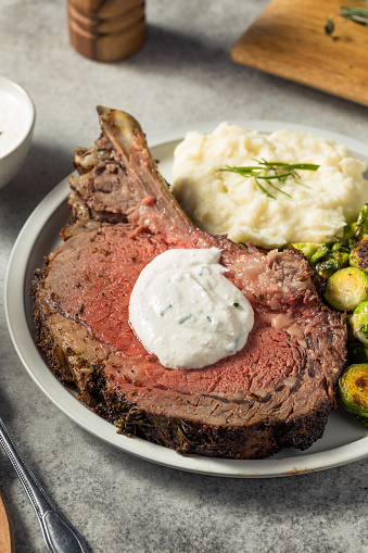 Homemade Standing Prime Rib Beef Roast with Horseradish Sauce and Potatoes