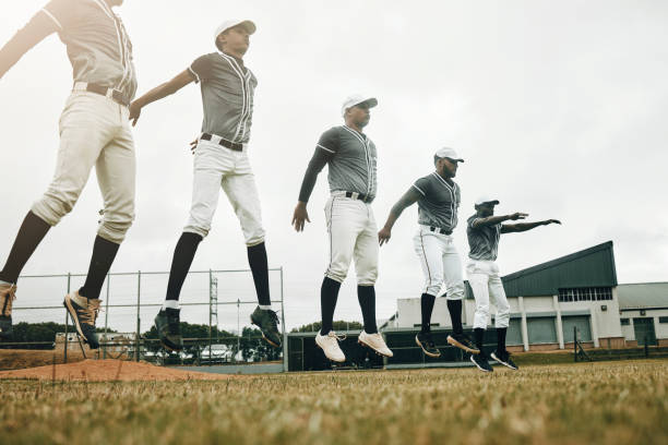 istock Baseball, training and exercise with a sport team preparing for a game on a grass pitch or field for sports. Fitness, teamwork and health with man friends getting ready during practice or a workout 1446344914