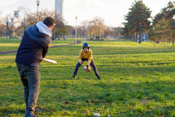 istock Father And His Son Play Baseball Together 1446347443
