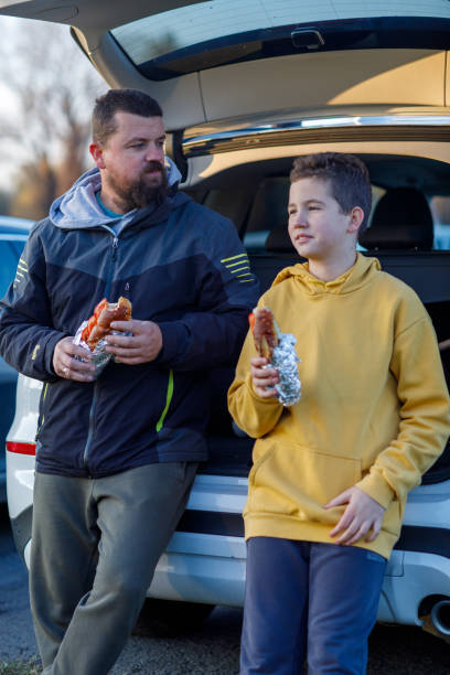 istock Father And Son Eat Sandwiches After Baseball Training 1446347677