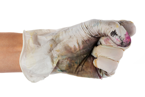 Gloves soiled in paint. Work gloves. Hand in dirty glove clenched into a fist isolate on white background. File contains clipping path.