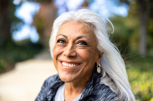 Portrait of a senior hispanic woman outdoors at workout