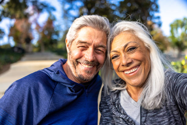 istock Mixed Race senior couple with smartphone taking selfies 1446349779