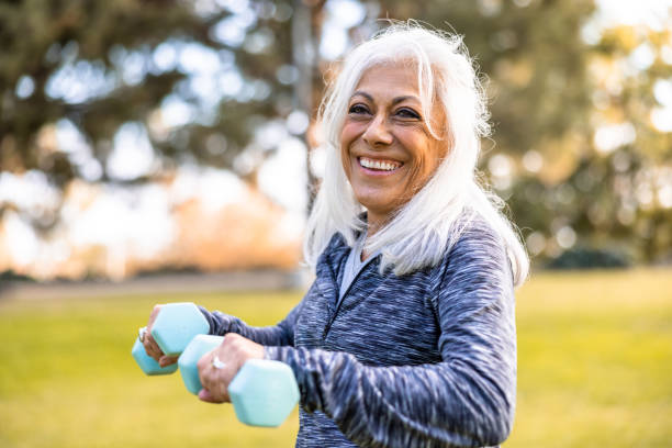 istock Senior Hispanic Woman Working Out with Weights 1446349803